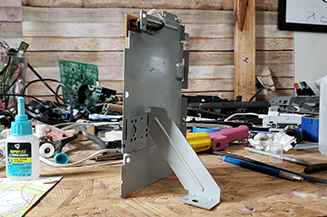 Back of a picture frame created from scrapped fax machine parts.