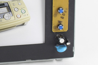 Photo frame with old fax machine parts.