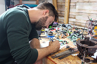 Josh A. Weston brainstorms his designs for fax machine art work.